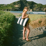 Model carrying the Shore Carryall on a coastal path